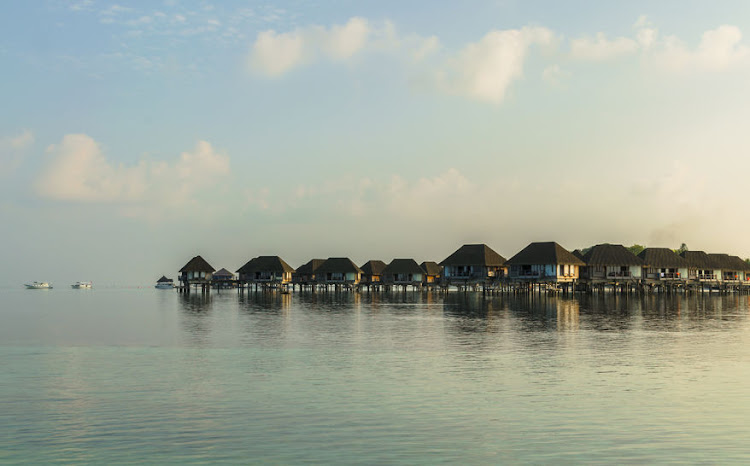 Many of the resorts in the Maldives have villas built on stilts over a turquoise sea.