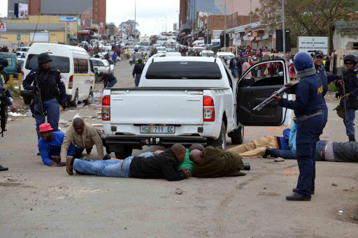 SCENE OF CHAOS: Scores of taxi drivers and touts were arrested after violence broke out at the Mamela Taxi Rank in the Mthatha CBD yesterday Picture: LOYISO MPALANTSHANE