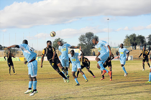 GETTING A HEADSTART: Mthatha Bucks striker Nkani Zwane, in black, who scored the all-important goal that fired Bucks to the National First Division, goes for a header against North West Shining Stars defender Mthokozisi Nkabinde during their ABC Motsepe League national playoffs match in Kimberley yesterday Picture: MAWANDE MVUMVU