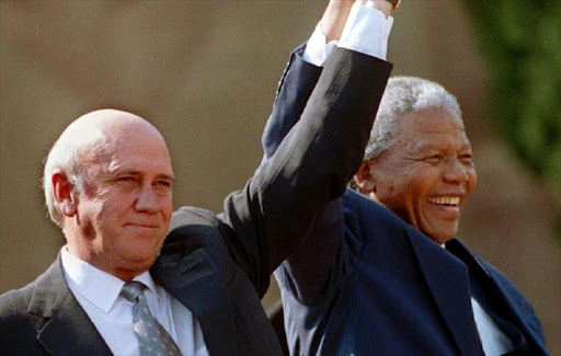 Former president FW de Klerk holds hands with the late president Nelson Mandela