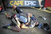 WOUNDED, NOT DEFEATED: James Schuurmans and Candice Marsh collapse after just finishing stage three in time