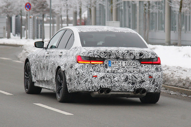 The quad exhausts reveal this to be the new M3 underneath the disguise. Picture: SPIEDBILDE/BRIAN WILLIAMS