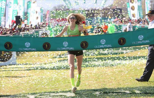 Camille Herron, from Oklahoma in the US wins the Women's race of the Comrades Marathon. She stopped running when she was handed a rose upon entering the arena thinking that she had finished but another runner came up next to and told her the finish line was still ahead so she narrowly beat the second placed runner. PICTURE: Jackie Clausen