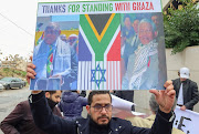 A demonstrator in Amman, Jordan, holds a sign during a protest as judges at The International Court of Justice hear South Africa's request for emergency measures to order Israel to stop its military action in Gaza.