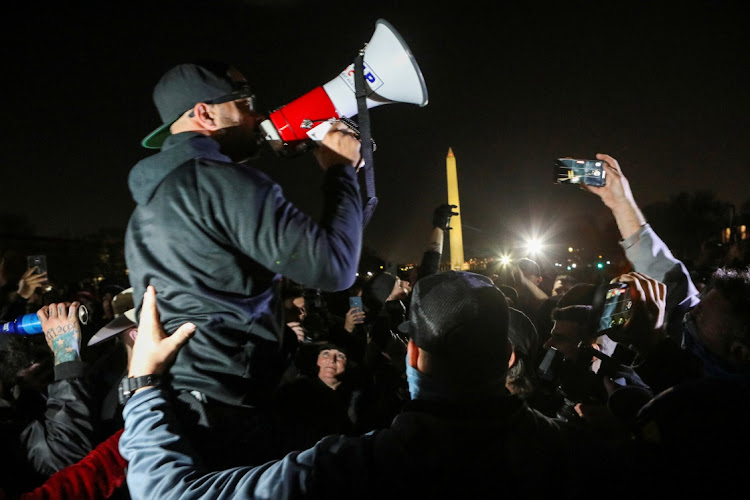 Proud Boys Chairman Enrique Tarrio addresses supporters of Donald Trump during a march near the Washington Monument.