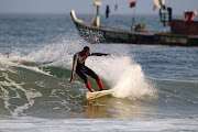 BLACK STAR RISING: A local surfer rides a wave into the beach at Busua in western Ghana.