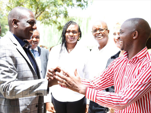 BDeputy President William Ruto with newly-elected FKF president Nick Mwendwa at Kasarani yesterday.