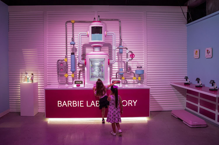 Guests in the Barbie Laboratory at the World Of Barbie in Santa Monica, California, US. The experience features life-sized replicas of Barbie's dreamhouse and camper van, as well as Barbie dolls and accessories from over six decades of fun.