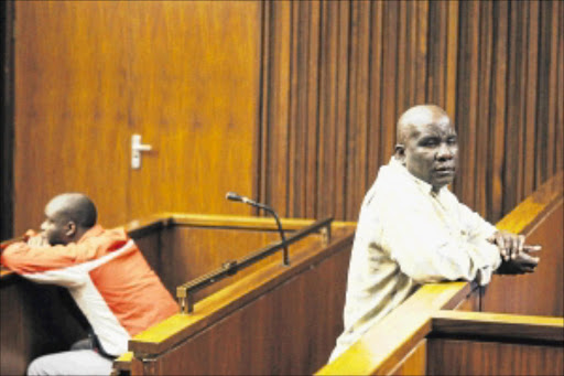 WORLDS APART: Booi Makhubela, right, and his son Rodgers during their sentencing in the Johannesburg High Court yesterday. Photo: Vathiswa Ruselo