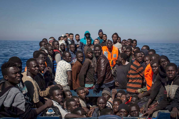 Refugees and migrants wait to be rescued near Lampedusa, Italy. Many migrants attempt the dangerous central Mediterranean crossing from Libya to Italy. File photo.