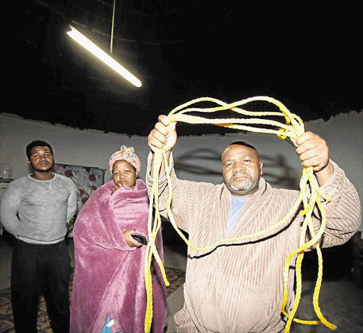 GRIEVING FAMILY: Mzuyanda Dlanaye and Minentle’s parents Sipho Dlanaye and Noluthando Dlanaye with the rope the boy hanged himself with Picture: LULAMILE FENI