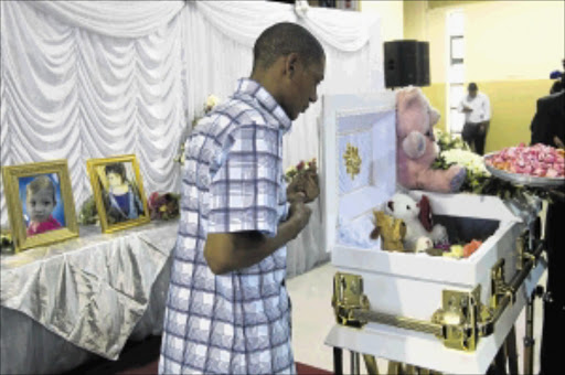 FAREWELL: Dimitri van Vuuren, the father of Jamie Naidoo, at the funeral of the abused child, who died last week