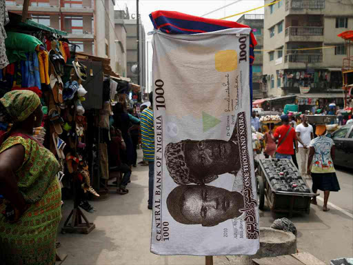A towel with a print of the Nigerian naira is displayed for sale at a street market in the central business district in Nigeria's commercial capital Lagos February 4, 2016. /REUTERS