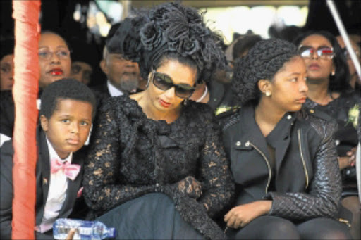 Grieving: Vuyo's son Sithenkosi, estranged wife Savita Mbuli and daughter Siphosihle at the funeral of the late Vuyo Mbuli PHOTO: Sibusiso Msibi