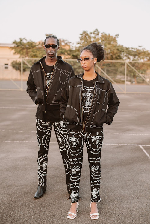 A photo of two models showcasing high quality merchandise from the iconic streetwear brand, Nairobi Apparel District.