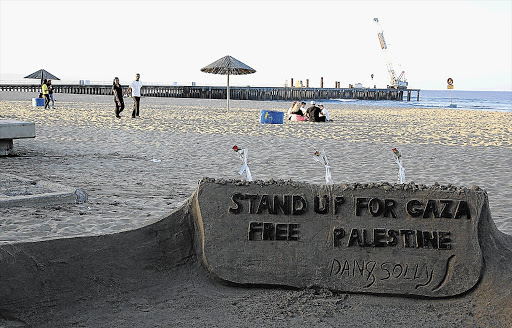 WRITTEN IN THE SAND: In their sculpture, artists Dan and Solly urge beachgoers at Bay of Plenty in Durban not to forget the invasion of the Gaza Strip by Israel