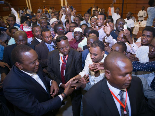 President Uhuru Kenyatta shakes hands with Kenyans who work and study in Sudan during a meet and greet session at the Corinthia Hotel, Khartoum, on Sunday, October 30, 2017. /PSCU