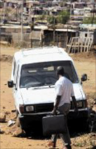 HAIR RAISER: Police recover a stole hearse at Freedom Park sqatter camp. Pic. Antonio Muchave. 02/09/2007. © Sowetan.