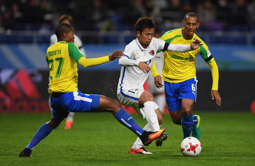 Atsutaka Nakamura of Kashima Antlers is challenged by Thapelo Morena (L) and Wayne Arendse of Mamelodi Sundowns during the FIFA Club World Cup second round match between Mamelodi Sundowns and Kashima Antlers at Suita City Football Stadium on December 11, 2016 in Suita, Japan. (Photo by Mike Hewitt - FIFA/FIFA via Getty Images)