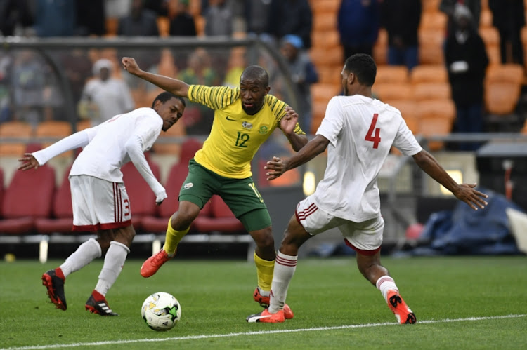 Nigel Nigel of Seychelles and Kamohelo Mokotjo of South Africa during the 2019 Africa Cup of Nations qualification match between South Africa and Seychelles at FNB Stadium on October 13, 2018 in Johannesburg, South Africa.