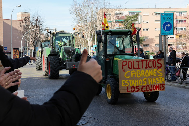 People show support as Spanish farmers drive their tractors during a protest over price pressures, taxes and green regulation, grievances shared by farmers across Europe, in Madrid, Spain, on February 21, 2024. Picture: REUTERS/VIOLETA SANTOS MOURA Violeta