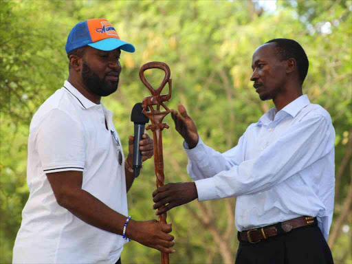 Mombasa Governor Hassan Joho receives a special walking stick carved by Kamba craftsmen at the Akamba Handicraft Industry in Mombasa town on Monday /BRIAN OTIENO