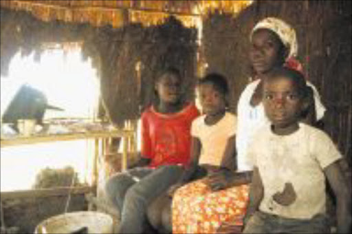 HARDSHIP: A 36-year-old widow, Busisiwe Zikhali of Mboza, Zululand, who lives in a shack that has no windows with her children, Maxoli,13, Jabulisile, 9 and Njabulo,7. Pic: THULI DLAMINI. 23/08/2009. © Sowetan