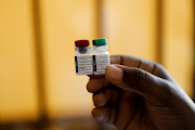 A nurse holds malaria vaccine vials before administering the jab to an infant at the Lumumba Sub-County hospital in Kisumu, Kenya, July 1, 2022.