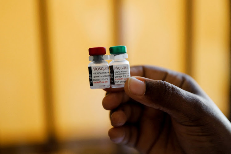 A nurse holds malaria vaccine vials before administering the jab to an infant at the Lumumba Sub-County hospital in Kisumu, Kenya, July 1, 2022.