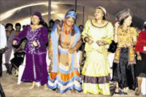 THE FIRST LADIES: President Jacob Zuma's three wives, from left, Pumelelo Ntuli, Sizakele Khumalo and Thobeka Mabhija dance at a function. Pic: Simphiwe Nkwali. 06/06/2009. © Sunday Times.