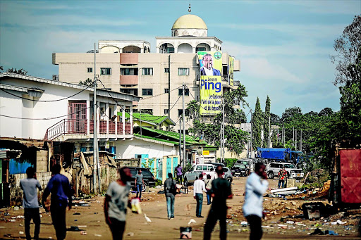 A blue police truck parks outside the headquarters of Gabonese opposition leader Jean Ping in Libreville yesterday. The results of the presidential election, announced on Wednesday, handed Ali Bongo a second term and extended his family's nearly five-decade-long rule. PHOTO: MARCO LONGARI/AFP