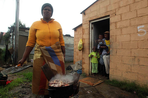 BACK TO BASICS: Nompumelelo resident Thembisa Mavuso has been without electricity for a week and as a result she has to cook outside Picture: SIBONGILE NGALWA