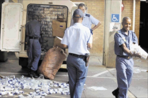 15 MARCH 2010 MONDAY: BREAK THROUGH: Polokwane police officers are registering an illegal cigarettes, street value of R100 000 which were confiscated from a van at Nirvana-Polokwane in Limpopo on Monday afternoon. Police spokesperson Moatshe Ngoepe said seven people including two police officers, Inspector and constable who were combating crime were arrested after the tip-off. These two police officers were arrested after they demanded a certain amount from five suspects but police received a tip-off and arrested them at the scene. Ngoepe said two police officers will be appeared before court soon while are still investigating the matter. Pic: ELIJAR MUSHIANA. 15/03/2010.