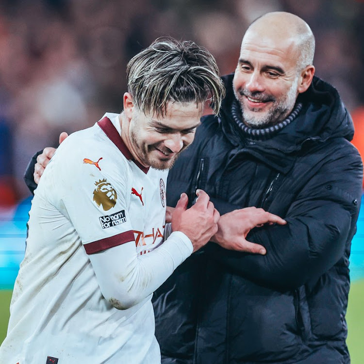 Manchester City winger Jack Grealish with manager Pep Guardiola