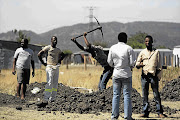 Nkaneng residents dig a grave during a site inspection by the Marikana commission of inquiry yesterday Picture: LAUREN MULLIGAN