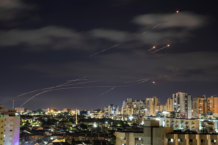 Streaks of light are seen as Israel's Iron Dome anti-missile system intercepts rockets launched from the Gaza Strip towards Israel, as seen from Ashkelon, Israel May 17, 2021.