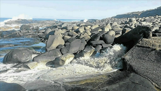 ANTIQUATED: The discharge point for the West Bank waste water treatment works outfall pipeline is on the rocks in the surf zone Picture: SUPPLIED