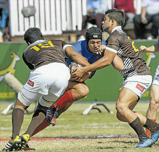 UNEVEN ODDS: Armich Lottering of Limpompo Blue Bulls tries to prise himself through the Border defence during the U18 Coca- Cola Craven Week at St Stithians College in Johannesburg yesterday Picture: GALLO IMAGES
