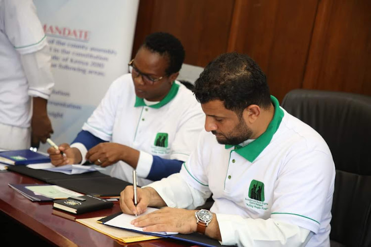 From left: Haki Jamii manager Lucy Baraza and Mombasa county assembly speaker Aharub Khatri signing the MoU which will see a four years partnership to improve reproductive health services in health facilities