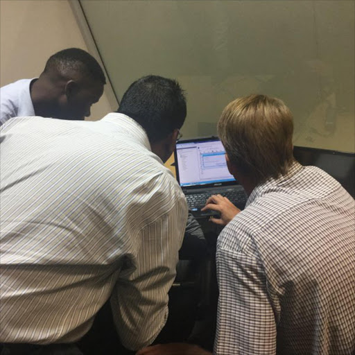 Gauteng education department technicians work on the admissions website.