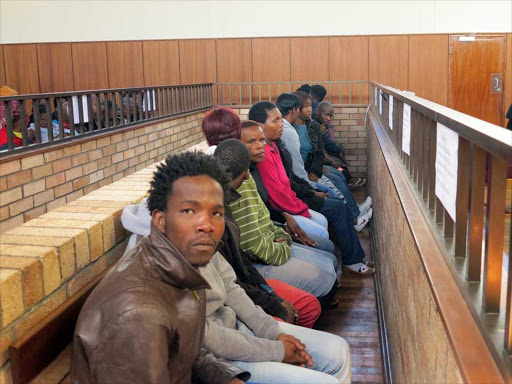 IN THE DOCK: Mandilakhe Fish Gqologqa stares at the camera. He is one of 15 accused of the murder of Samkelo Phutuma who was linked to the rape of an Mdantsane woman Picture: MALIBONGWE DAYIMANI