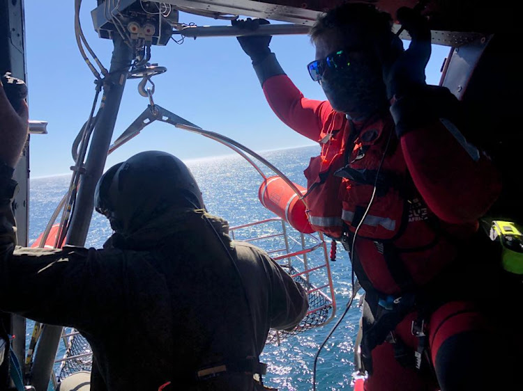 The SA Air Force Oryx prepares to lower a paramedic and a rescue swimmer onto the deck of a trawler to attend to a sick crew member on November 20 2020.