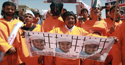 Yemenis wearing orange jumpsuits, similar to those worn by prisoners at the US detention centre in Guantanamo Bay, hold a protest demanding the release of inmates on hunger strike.