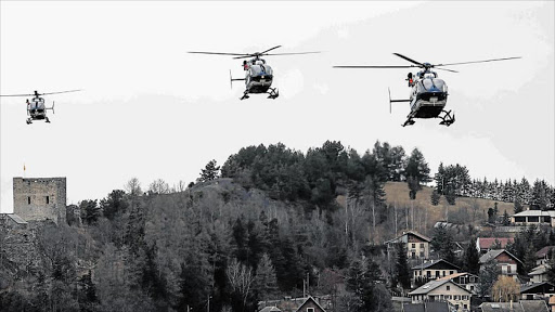 MAPPING THE SITE: Helicopters take off for another search and rescue operation from Syne Les Alpes, France, yesterday. Search crews planned to resume helicopter flights to the remote mountainside in southern France where Germanwings Flight 4U 9525 from Barcelona to Düsseldorf crashed after a rapid descent Picture: EPA