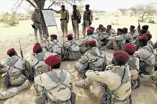 HOW TO DODGE A BULLET: A Spanish soldier trains Mauritanian special forces during Flintlock 2015, a US-led military exercise, in Chad last week