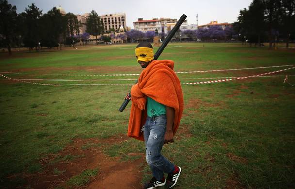 A masked protestor is seen on the lawns of The Union Buildings during a march by a group of Fees Must Fall protesters to the Union Buildings in Pretoria calling for free tertiary education. In mid October 2015, a student led protest movement began in response to an increase in fees at South African universities. The Protests started at the University of Witwatersrand (Wits) and spread to various other universities including the University of Cape Town and Rhodes University. The rapid spread to other universities resulted in widespread damage and discontentment amongst the authorities.