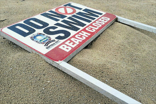 MIXED SIGNALS: This sign was lying on the sand at Nahoon Corner yesterday but BCM said there had been no beach closures. Picture: SUPPLIED