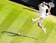 DESTROYER: Talented young Bulgarian, Grigor Dimitrov, is seen here on his way to a three-set demolition of reigning Wimbledon champion Andy Murray in their quarterfinal on Centre Court yesterday