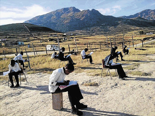 Pupils at Nomkolokoto Junior Secondary School in the Mount Frere district, Eastern Cape, write exams outdoors because there are no classrooms