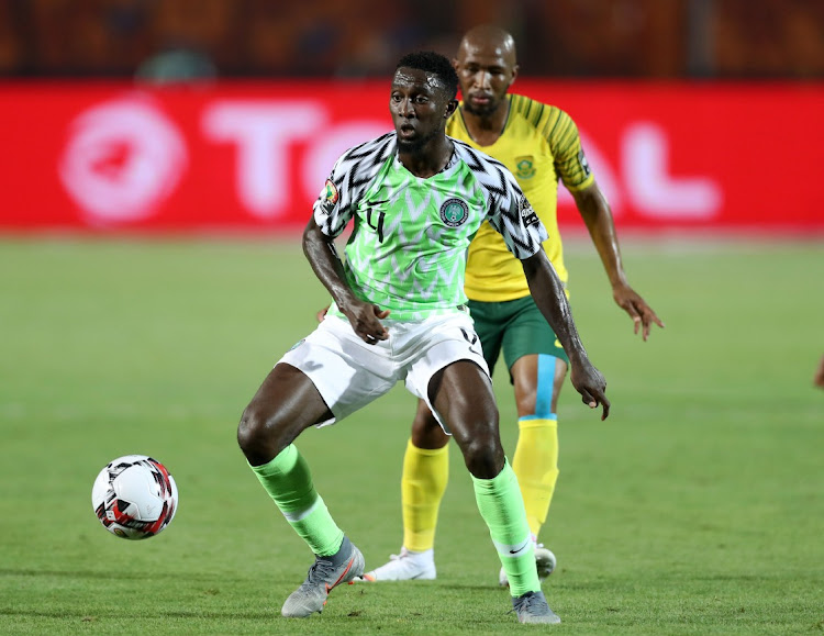 Wilfred Ndidi of Nigeria is challenged by Kamohelo Mokotjo of Bafana Bafana during the 2019 Africa Cup of Nations quarterfinal at Cairo International Stadium in July 2019.